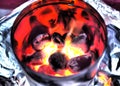 Close-up of glowing coals on fire in charcoal chimney starter Royalty Free Stock Photo