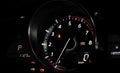 Close up glowing tachometer needle at zero engine speed on the car dashboard Royalty Free Stock Photo