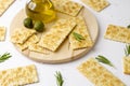Close up of gluten free crackers with rosemary, olives and olive oil