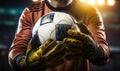 Close up Goalkeeper securely holds a soccer ball after a critical save