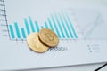 close-up. gold bitcoins and a financial chart on the desktop. Royalty Free Stock Photo