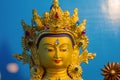 Close up of Gold covered statue of buddhist deity of compassion Chenrezig.