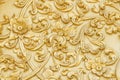 Gold engraving stucco with flower leaf branch patterns decorative on  concrete wall in temple background Royalty Free Stock Photo