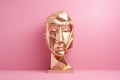 Close up of gold metallic face sculpture on pink background, created using generative ai technology Royalty Free Stock Photo