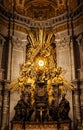 Close-up of a gold-plated throne surrounded by gargoyles with ancient stone walls.