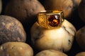 Close-up gold ring jewelry on river gravel background.Vintage ring,ancient jewelry