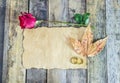 Close up gold ring, red rose, dry leaves and old paper on wooden Royalty Free Stock Photo