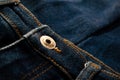 gold and shiny button navy blue jeans fabric texture. Royalty Free Stock Photo