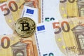 Bitcoin on a stack of 50 Euros Royalty Free Stock Photo