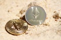 Close up of bitcoin and ethereum on sandstone