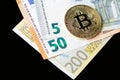 Close-up of a golden bitcoin on euro currency. Royalty Free Stock Photo