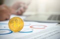 Close-up golden bitcoin on the office desk with businessman working background Royalty Free Stock Photo