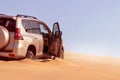 Close up of a golden car stuck in the sand in the Namib desert