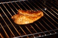 Close up of golden chicken breast on grill