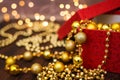 Close up golden christmas decoration balls from red gift box on dark wooden background and bokeh garland Royalty Free Stock Photo