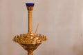 Close-up of golden church candlestick for many candles