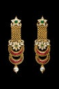 Close up of golden earrings over black background