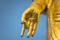 Close up on a golden hand doing Buddhist mudra gesture called dharmachakra.