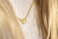 Close up Golden heart Necklace on neck with blond hair Royalty Free Stock Photo