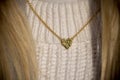 Close up Golden heart Necklace on neck with blond hair Royalty Free Stock Photo