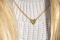 Close up Golden heart Necklace on neck with blond hair Royalty Free Stock Photo