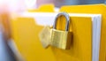 Golden Padlock Securing Yellow Document Folder with Blurred Background security data Royalty Free Stock Photo