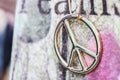 Close up of golden peace symbol necklace