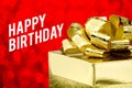 Close up Golden present with big bow and Happy Birthday word at Royalty Free Stock Photo