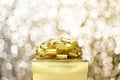 Close up Golden present box with big bow at bokeh white blur background, Leave space on top to adding your content Royalty Free Stock Photo