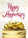 Close up Golden present box with Happy Anniversary word and confetti blur background Royalty Free Stock Photo