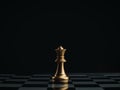 Close up the golden queen chess piece standing alone on a chessboard on dark background.