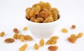 Close-up of golden raisins dry grapes in a ceramic bowl over white background Royalty Free Stock Photo