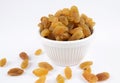 Close-up of golden raisins dry grapes in a ceramic bowl over white background Royalty Free Stock Photo