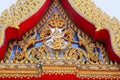 Close up of golden red carving. The temple beautifully adorns wooden carvings depicting Buddha`s life familiarized by Jataka Tale