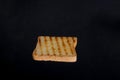 Close up of golden slice of toast on black background Royalty Free Stock Photo