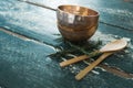 Golden steel bowl, spatula and spoon on table