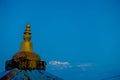 Close up of a golden structure taken in camera with a beautiful mountain view Annapurna during sunrise at Sarangkot