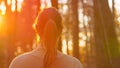 CLOSE UP: Golden sunbeams shine on brunette woman going for a walk in forest. Royalty Free Stock Photo