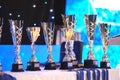 Close-up of golden trophies lined up at a dance event. Collection of trophies. Award cups close up