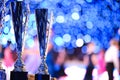 Close-up of golden trophies lined up at a dance event. Collection of trophies. Award cups closeup with space for text on