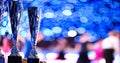 Close-up of golden trophies lined up at a dance event. Collection of trophies. Award cups closeup with space for text on