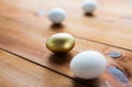 Close up of golden and white easter eggs on wood Royalty Free Stock Photo
