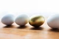 Close up of golden and white easter eggs on wood Royalty Free Stock Photo