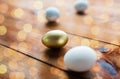 Close up of golden and white easter eggs on wood Royalty Free Stock Photo