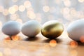Close up of golden and white easter eggs on wood Royalty Free Stock Photo