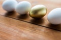 Close up of golden and white easter eggs on wood Royalty Free Stock Photo