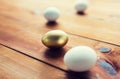 Close up of golden and white easter eggs on wood Royalty Free Stock Photo