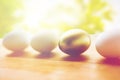 Close up of golden and white easter eggs on wood Royalty Free Stock Photo