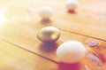 Close up of golden and white easter eggs on wood Royalty Free Stock Photo