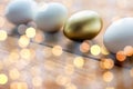 Close up of golden and white easter eggs on wood Royalty Free Stock Photo